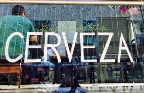 Chalkboard art on the windows of the Merchant Tavern, Toronto. This says "Cerveza" or beer in Spanish.